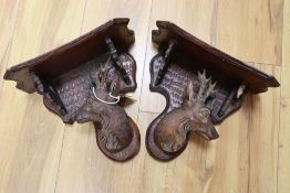A pair of Black Forest walnut deer's head wall brackets, late 19th century, height 24cm