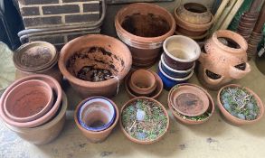 Approximately 25 assorted garden planters and dishes bases, mainly terracotta, largest diameter