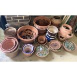 Approximately 25 assorted garden planters and dishes bases, mainly terracotta, largest diameter