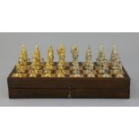 A figural silvered and gilded metal chess set in fitted rosewood and boxwood folding box/chess