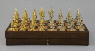 A figural silvered and gilded metal chess set in fitted rosewood and boxwood folding box/chess