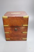 A mid 19th century mahogany and brass bound decanter case, containing three decanters and two