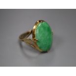 A yellow metal and oval cabochon jadeite set ring, size J, gross 4.6 grams, stone dimensions approx.