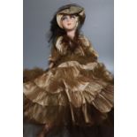 A painted felt and composition fashion doll, 75cm high with silk and taffeta dress