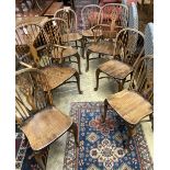 A set of eight early 20th century elm and beech Windsor wheelback dining chairs, with crinoline