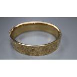 A 9ct engraved gold hollow hinged bangle, Cropp & Farr, Birmingham 1974, 20.9g.