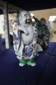 A Japanese Kutani figure of Hotei, 21cm