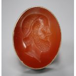 A 9ct and intaglio carnelian oval ring, carved with the head of a gentleman to dexter, size W, gross