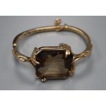A 1970's 9ct gold and large smoky quartz set hinged bracelet, gross 34.9 grams.CONDITION: Stone very