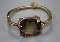 A 1970's 9ct gold and large smoky quartz set hinged bracelet, gross 34.9 grams.CONDITION: Stone very