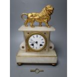 A 19th century French eight day alabaster mantel clock, surmounted by a gilt metal model of a