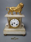 A 19th century French eight day alabaster mantel clock, surmounted by a gilt metal model of a