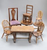 A group of miniature wood furniture including three Windsor chairs, a vase splat chair, two tripod