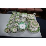 A Victorian Nash & Co part tea service, with floral decoration on a gilt-heightened apple green