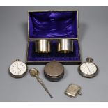 A cased pair of silver napkin rings, a silver pill box and spoon, a silver vesta case and two silver