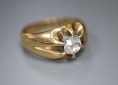 An early 20th century yellow metal and claw set solitaire diamond ring, size N, gross 7.1 grams, the