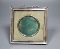 A white metal mounted photograph frame, with ribbon crest, 14cm.