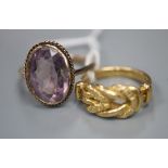 A gold 'knot' ring (marks rubbed but tests as 18ct), 5 grams, and a 9ct gold and amethyst ring,