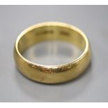 An 18ct yellow gold wedding ring, size M, 5.7 grams.