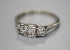 An 18ct and plat, graduated three stone diamond ring, size N/O, gross 3 grams.CONDITION: Central