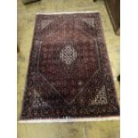 A Hamadan red ground floral rug, 170 x 112cm