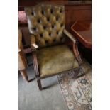 A George III style mahogany library chair, upholstered in buttoned green leather, width 58cm