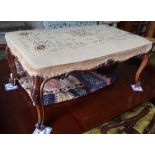 A Victorian carved walnut dressing stool, with tapestry seat, width 96cm depth 60cm, height 43cm