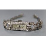 A lady's Art Deco white metal (stamped All Plat) and diamond set cocktail watch, on flexible white