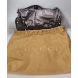 A Gucci handbag, in brown holder