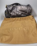 A Gucci handbag, in brown holder