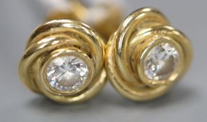 A pair of modern 750 yellow metal and solitaire diamond set 'knot' ear studs, 8mm, gross 3.8 grams.