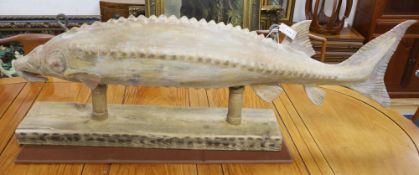 A carved wood sturgeon, on wood stand, length 140cm