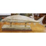 A carved wood sturgeon, on wood stand, length 140cm