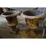 A pair of Victorian faux marble cast iron urn campana garden urns, 39cm diameter, height 46cm