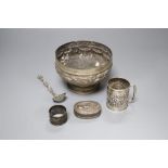 An Edwardian silver christening mug, a Victorian silver foliate sifter spoon, an Indian? bowl,