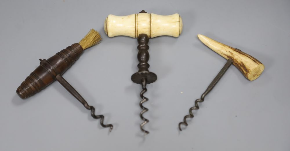 A late Victorian bone handled corkscrew, a wood handle corkscrew and an antler handle corkscrew