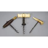 A late Victorian bone handled corkscrew, a wood handle corkscrew and an antler handle corkscrew