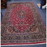 A Tabriz style burgundy ground carpet, 310 x 196cm
