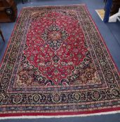 A Tabriz style burgundy ground carpet, 310 x 196cm