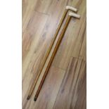 Two late 19th/early 20th century ivory handled walking canes, longest 91cm