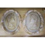 A pair of painted resin Claudius plaques, height 38cm