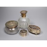 Three various tortoiseshell and silver pique-mounted glass toilet jars and a small silver circular