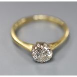 A modern 18ct gold and solitaire diamond ring, size M, gross 2.9 grams, the stone weighing