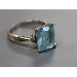 A modern 18ct white gold, blue topaz and diamond set dress ring, size S, gross 6.2 grams.