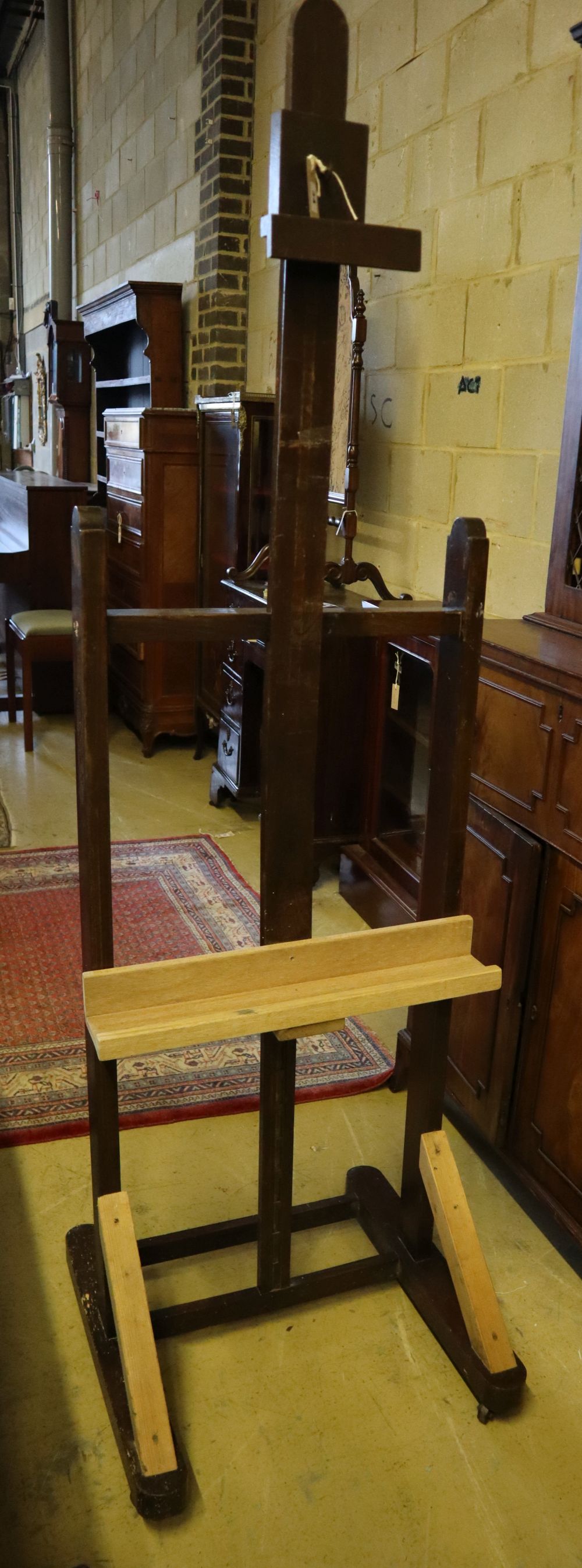 An early 19th century oak studio artist's easel, width 55cm (incorporates later timber)