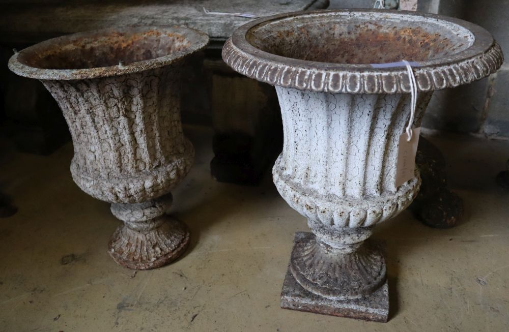 A pair of Victorian cast iron campana garden urns (one lacking plinth foot and rim), taller 49cm