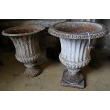 A pair of Victorian cast iron campana garden urns (one lacking plinth foot and rim), taller 49cm