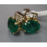 A modern pair of 750 yellow metal, oval cut emerald and four stone diamond set ear studs, 9mm, gross