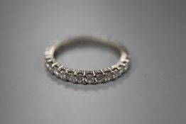 A platinum and diamond full eternity ring, claw-set with small round diamonds, size N, gross 2.8