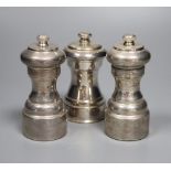 Three assorted modern silver mounted pepper mills, including a pair, London, 1980, tallest 10.5cm.